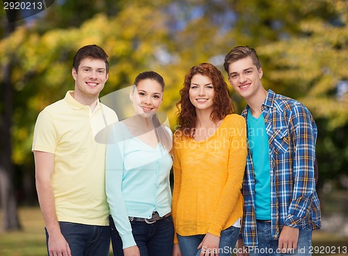 Image of group of smiling teenagers over green park
