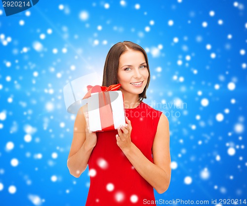 Image of smiling woman in red dress with gift box