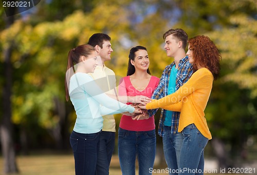 Image of group of smiling teenagers over green park