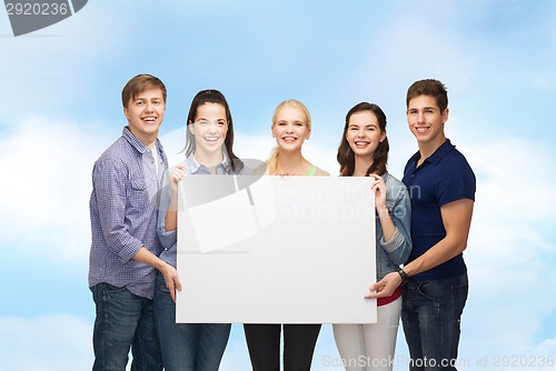 Image of group of standing students with blank white board