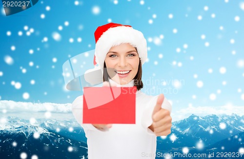 Image of woman in santa helper hat with blank red card