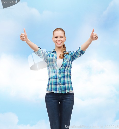 Image of smiling girl in casual clothes showing thumbs up