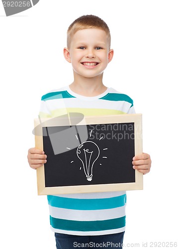 Image of smiling little boy with blank blackboard