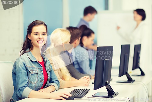 Image of smiling teenage girl with classmates and teacher
