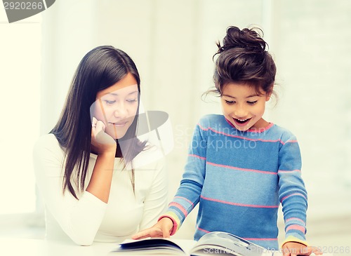 Image of mother and daughter with book