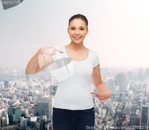 Image of smiling young woman in blank white t-shirt