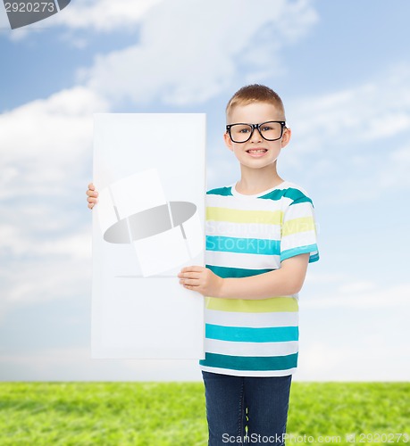 Image of smiling boy in eyeglasses with white blank board