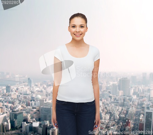 Image of smiling young woman in blank white t-shirt