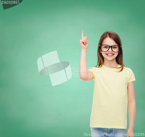 Image of smiling cute little girl in black eyeglasses