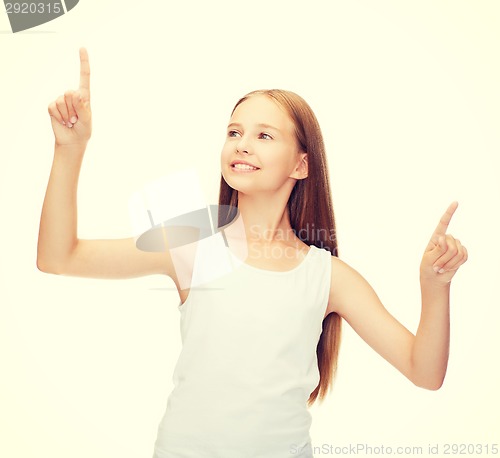 Image of girl in blank white shirt pointing to something