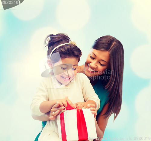 Image of happy mother and child girl with gift box