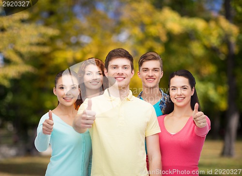Image of group of smiling teenagers over green park