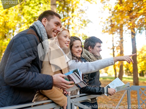 Image of group of friends with map outdoors