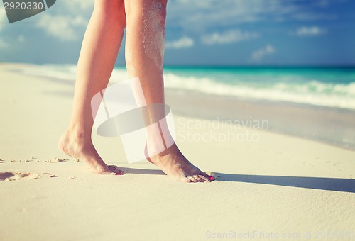 Image of closeup of woman legs on sea shore