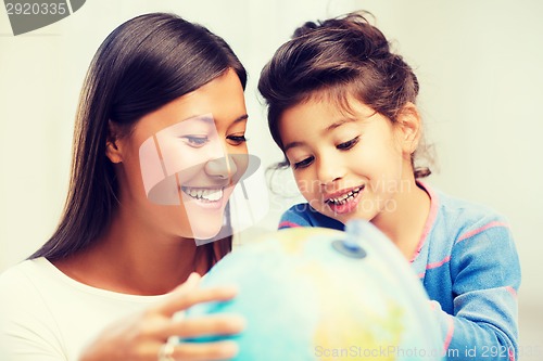 Image of mother and daughter with globe