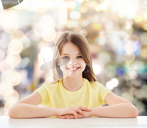 Image of beautiful little girl sitting at table