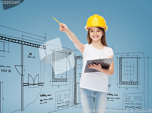 Image of smiling little girl in hardhat with clipboard