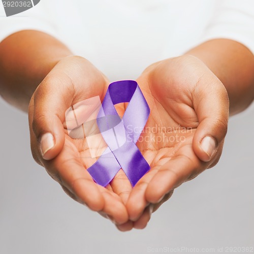 Image of hands holding purple awareness ribbon