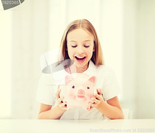 Image of child with piggy bank