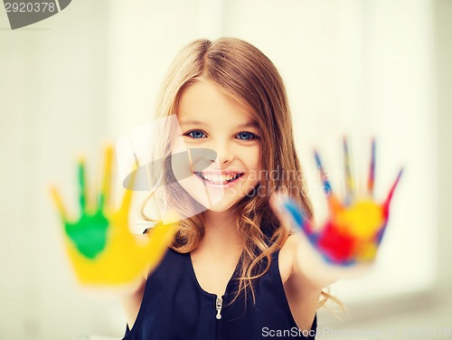 Image of smiling girl showing painted hands