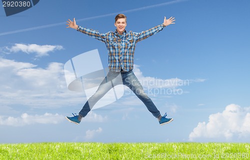 Image of smiling young man jumping in air