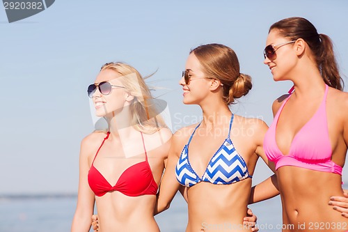 Image of group of smiling young women in sunglasses