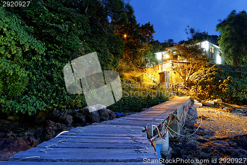 Image of boat pier and small house at night