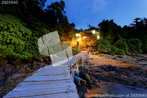 Image of boat pier and small house at night