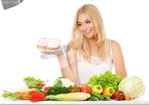 Image of Woman with vegetables and cake