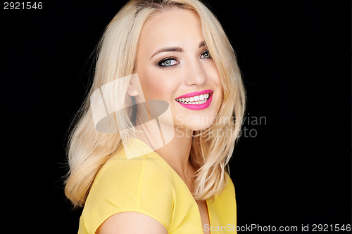 Image of Smiling beautiful blond woman wearing makeup