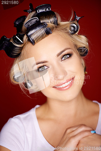 Image of Beautiful blond with her hair in curlers