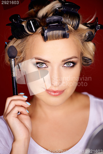 Image of Beauty portrait of a blond wearing curlers