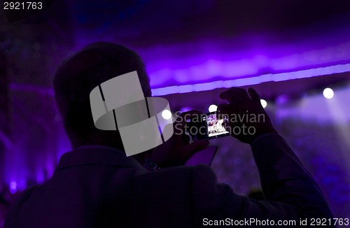 Image of Man taking pictures during a concert