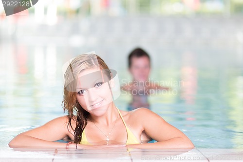 Image of Young woman in the swimming pool.