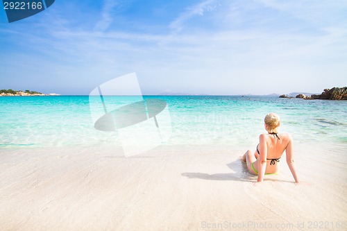 Image of woman relaxing on the beach.