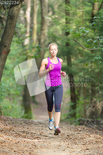 Image of Pretty young girl runner in the forest. 