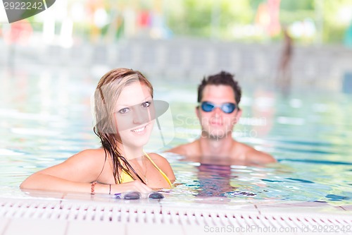Image of Young couple in the swimming pool.
