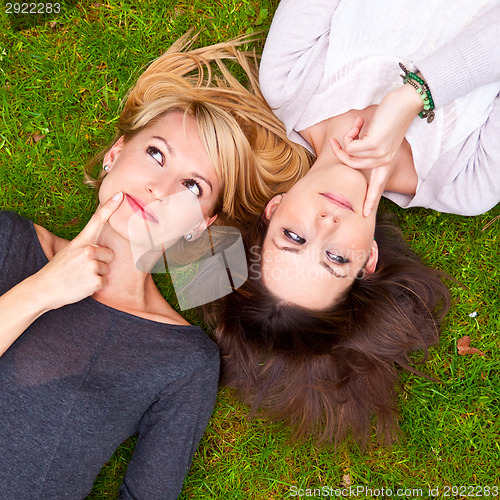 Image of Two girls lying in the grass