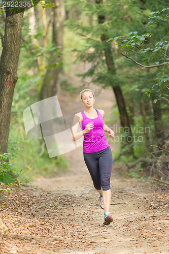 Image of Pretty young girl runner in the forest. 