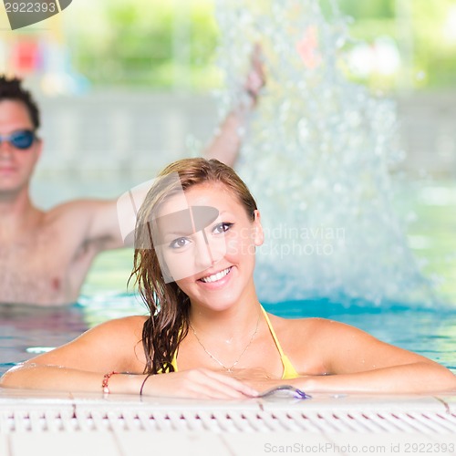 Image of Young couple in the swimming pool.