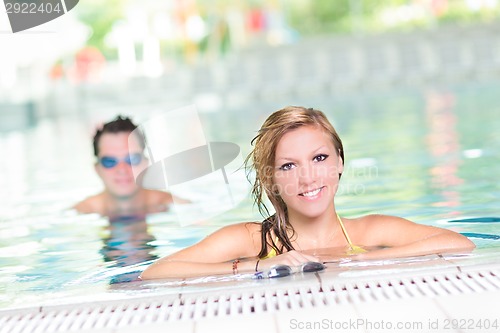 Image of Young couple in the swimming pool.