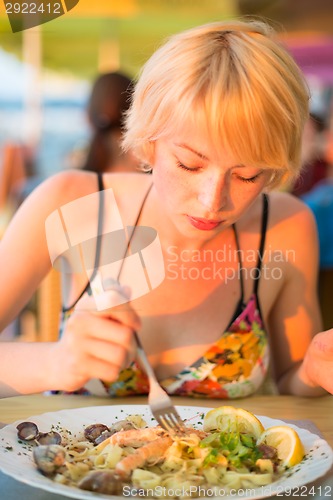 Image of Woman eating healthy food.