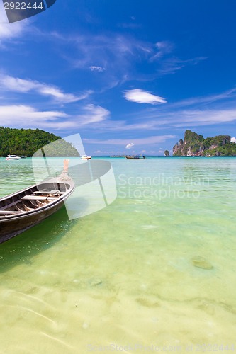 Image of Wooden boat on a tropical beach.