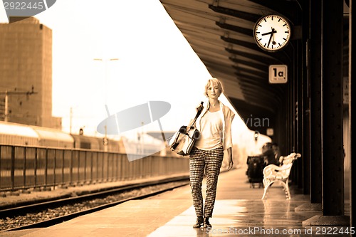 Image of Lady waiting at the railway station.