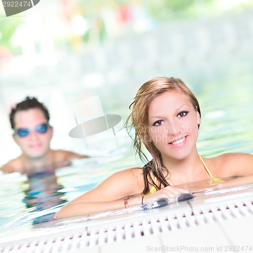 Image of Young couple in the swimming pool.