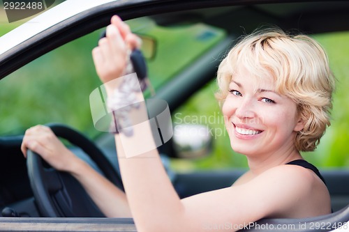 Image of Lady, driving showing car keys out the window.