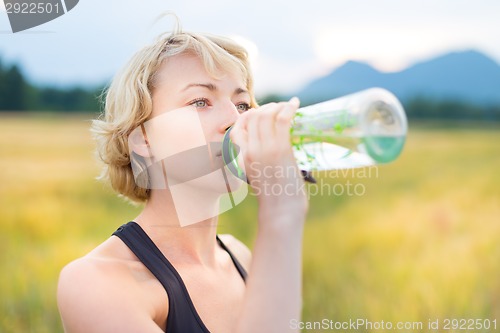 Image of Portrait of woman drinking water outdoor