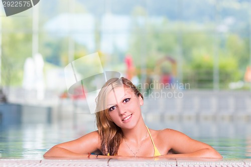 Image of Young woman in the swimming pool.