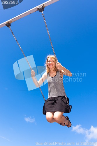 Image of Woman swinnging on a swing.