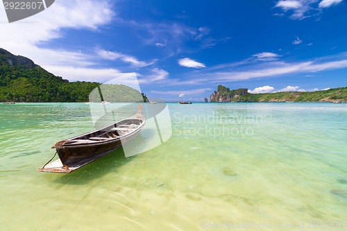 Image of Wooden boat on a tropical beach.